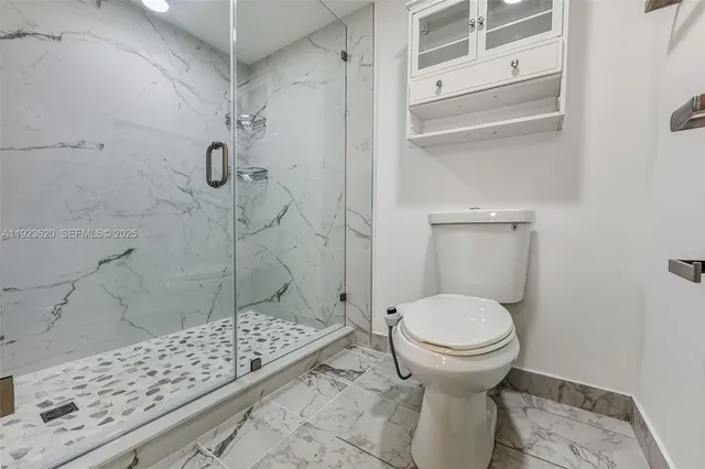 a bathroom with a toilet and shower