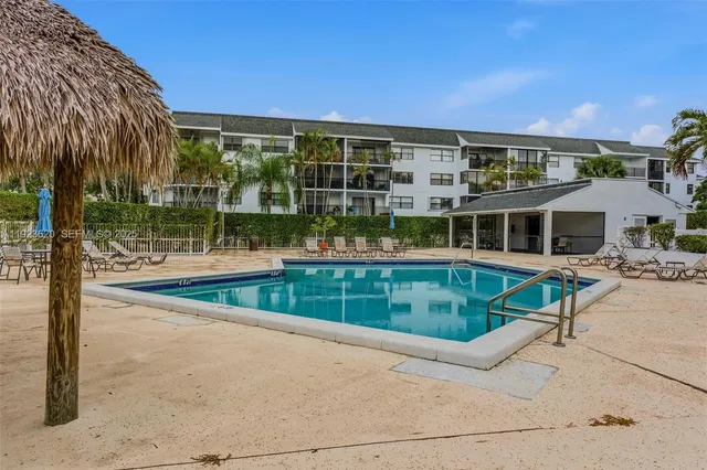 an aerial view of lake and residential houses with outdoor space
