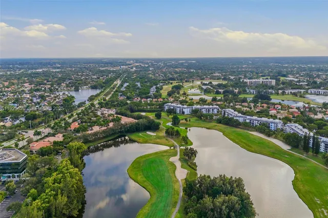 an aerial view of a house with a yard and lake view