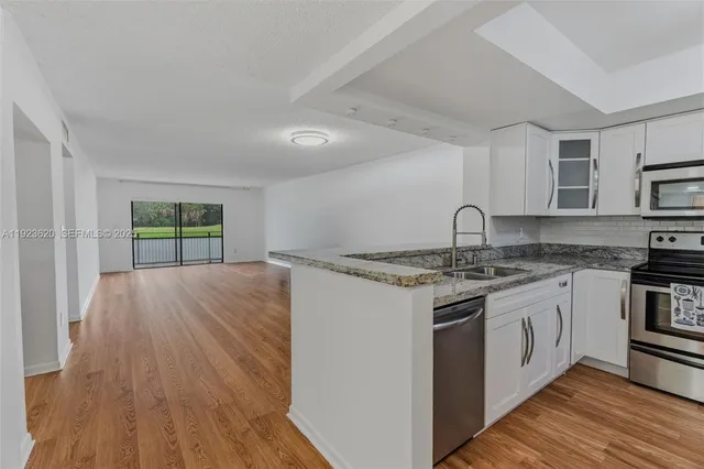 a kitchen with stainless steel appliances granite countertop a stove and a sink