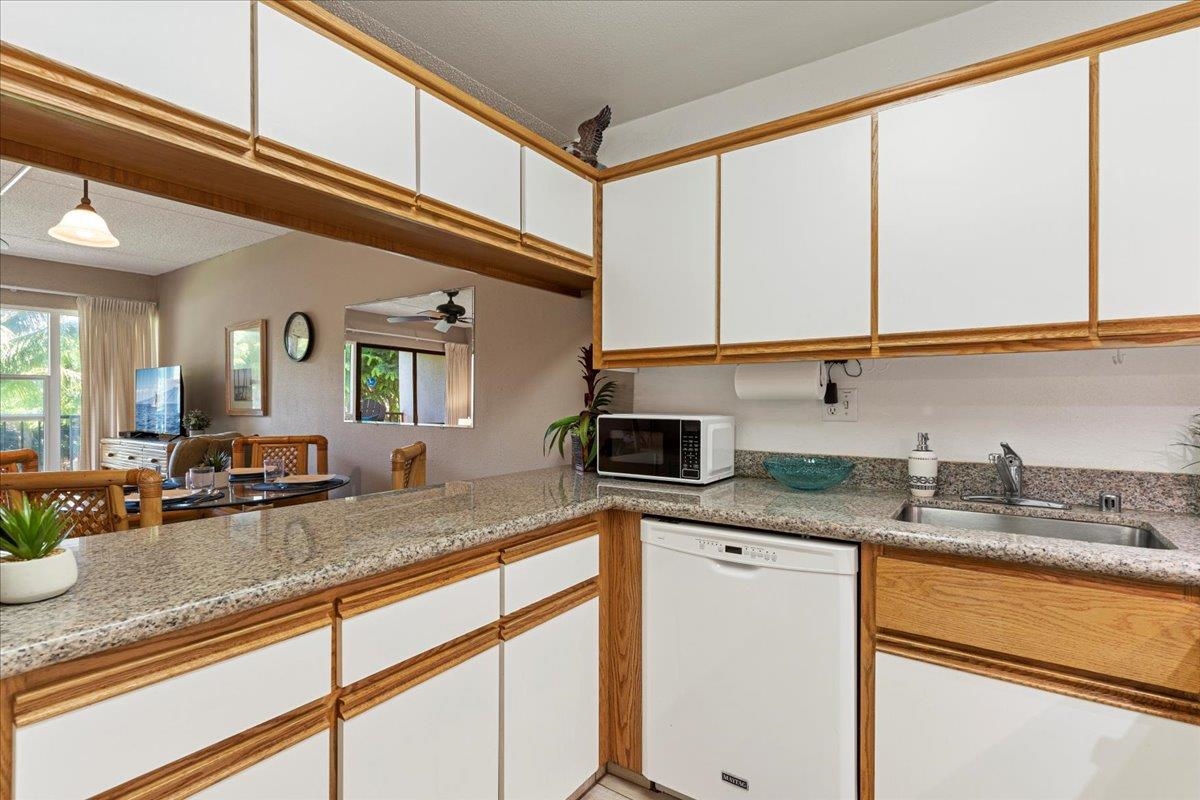 2531 South Kihei Road, Unit C317 Kihei, HI 96753 - Photo 14 of 32 a kitchen with granite countertop stainless steel appliances a sink and cabinets