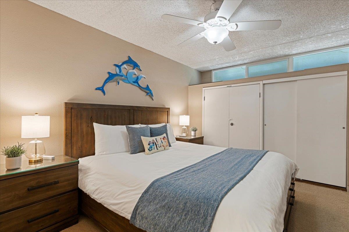 2531 South Kihei Road, Unit C317 Kihei, HI 96753 - Photo 25 of 32 a bedroom with a bed and a chandelier