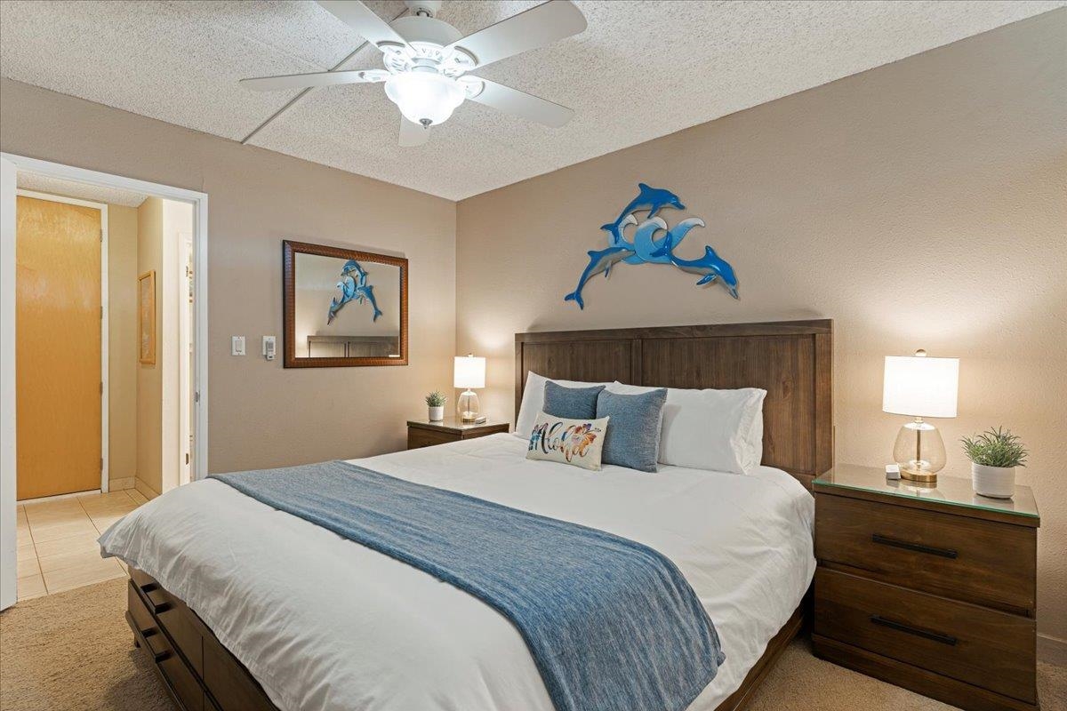 2531 South Kihei Road, Unit C317 Kihei, HI 96753 - Photo 26 of 32 a bedroom with a bed and a chandelier