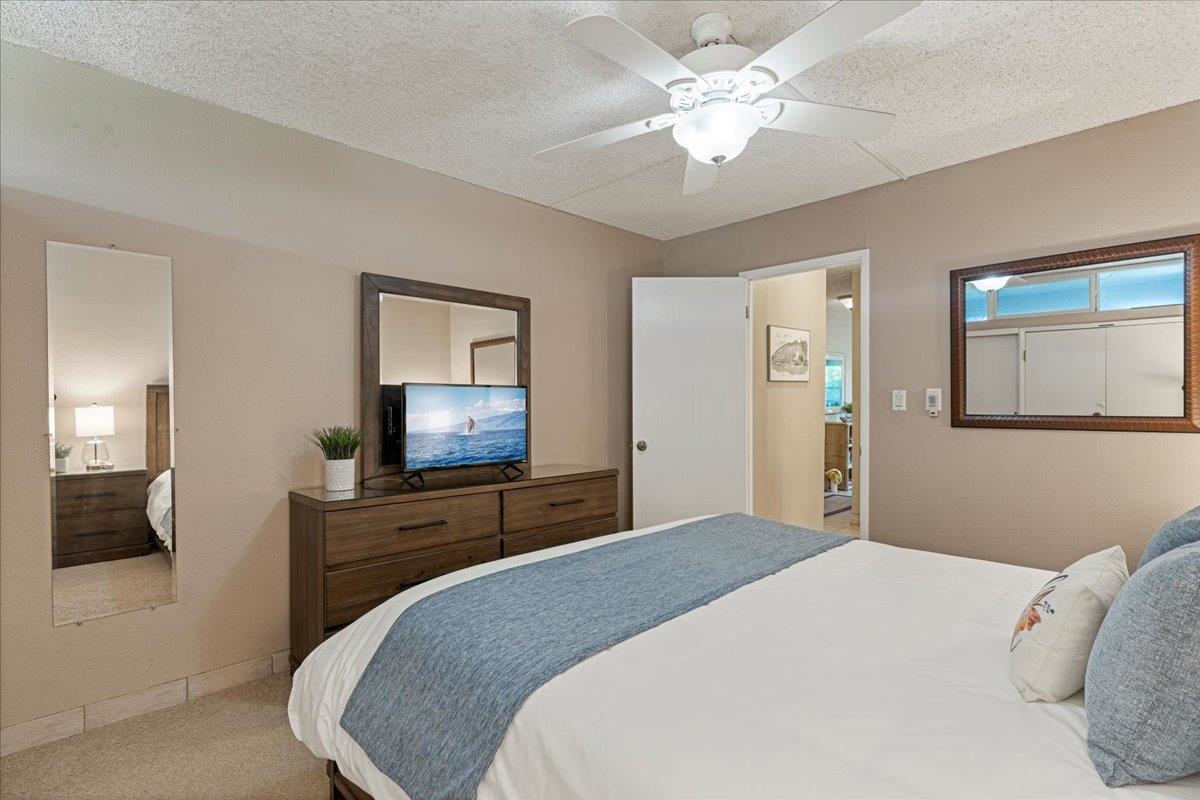 2531 South Kihei Road, Unit C317 Kihei, HI 96753 - Photo 29 of 32 a bedroom with a bed and a flat screen tv