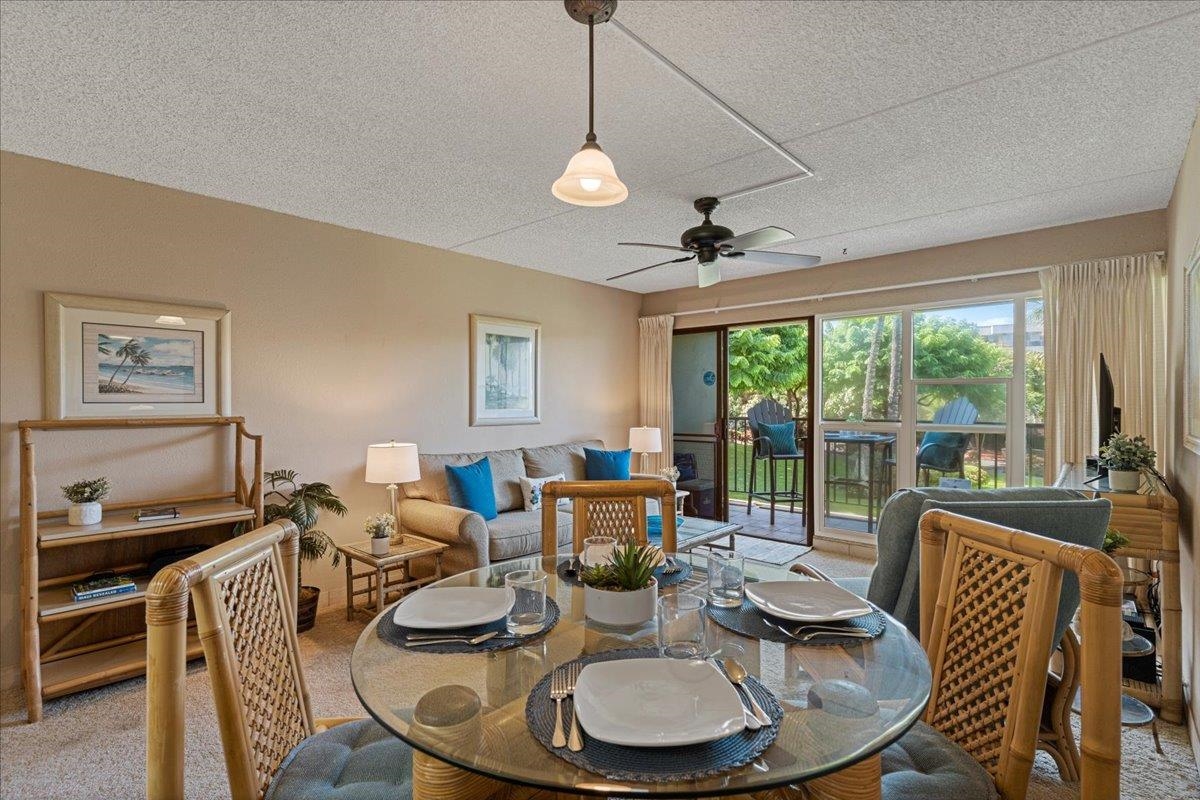 2531 South Kihei Road, Unit C317 Kihei, HI 96753 - Photo 7 of 32 a dining room with furniture a chandelier and wooden floor