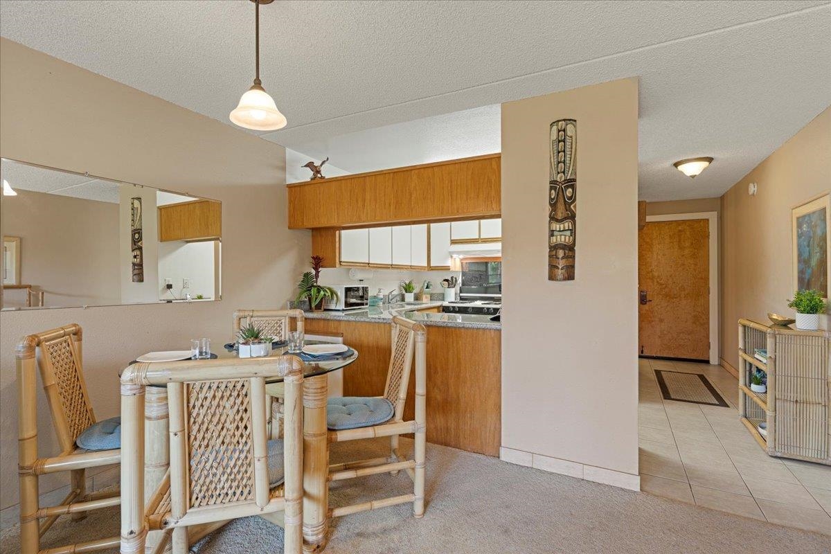 2531 South Kihei Road, Unit C317 Kihei, HI 96753 - Photo 8 of 32 a dining room with furniture a window and a kitchen view