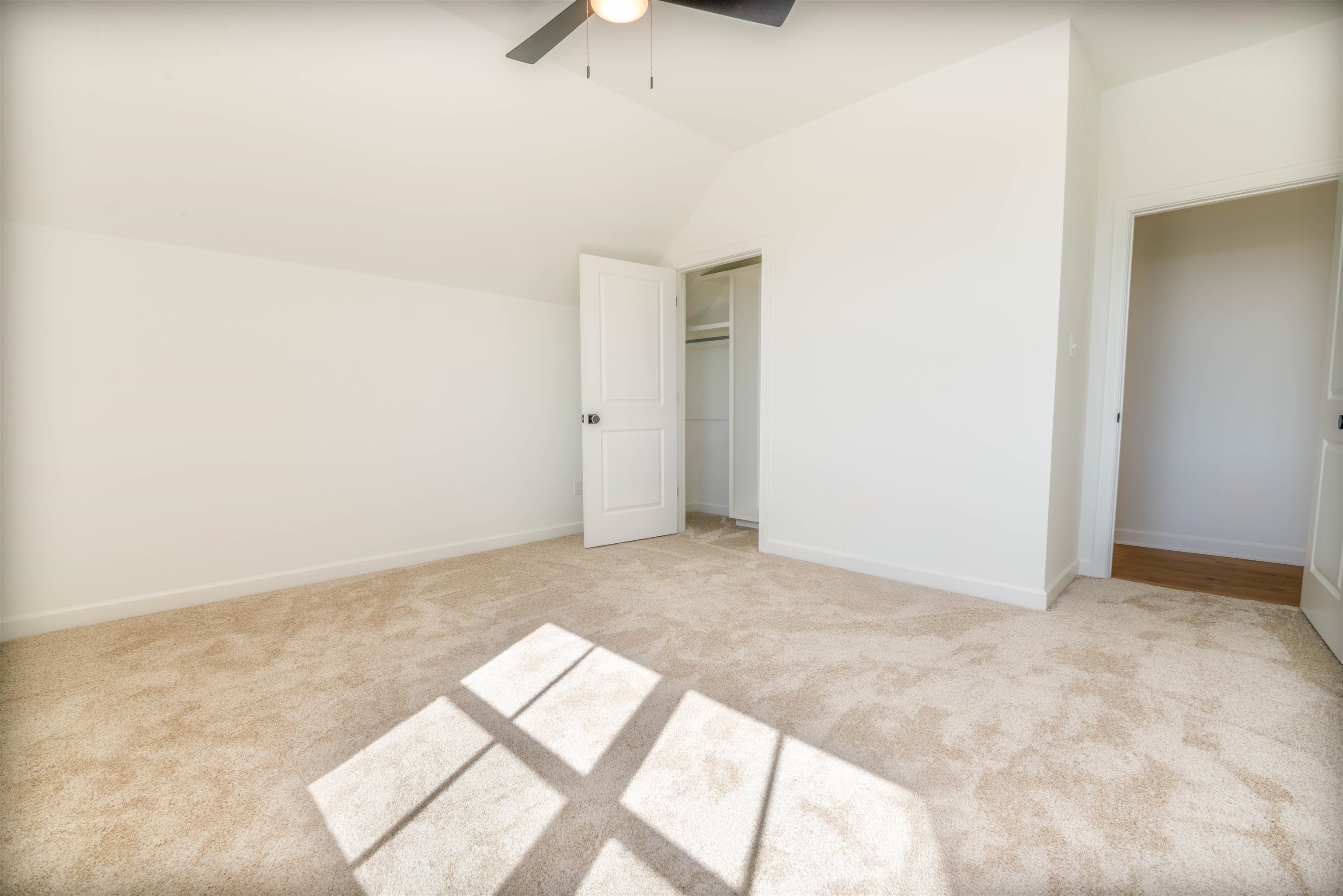 30 Rambling Rex Trail Piperton, TN 38017 - Photo 21 of 27 Unfurnished bedroom featuring ceiling fan, baseboards, carpet, and lofted ceiling