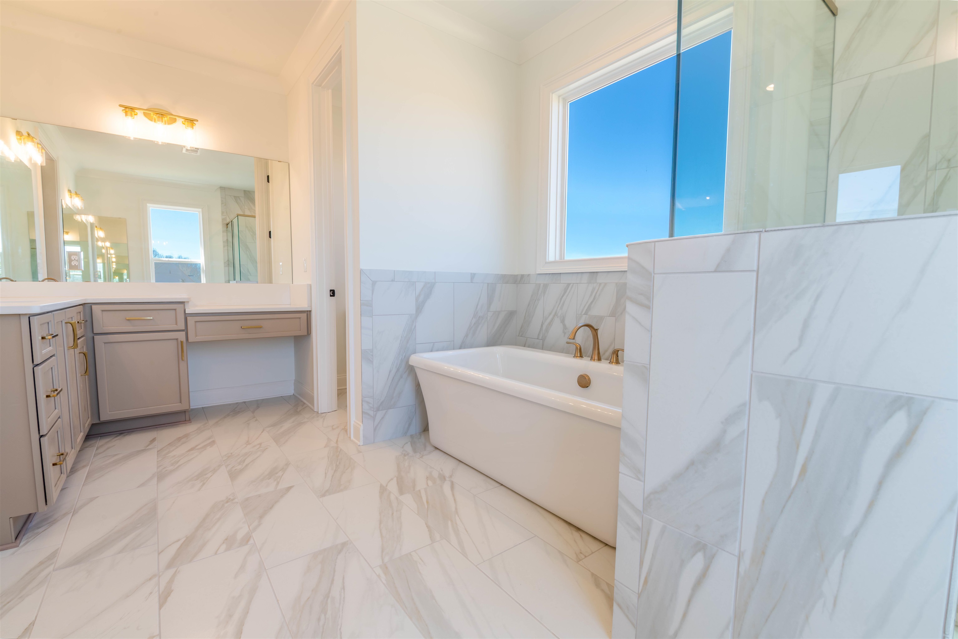 30 Rambling Rex Trail Piperton, TN 38017 - Photo 23 of 27 Full bath with marble finish floor, a marble finish shower, tile walls, a freestanding bath, and vanity