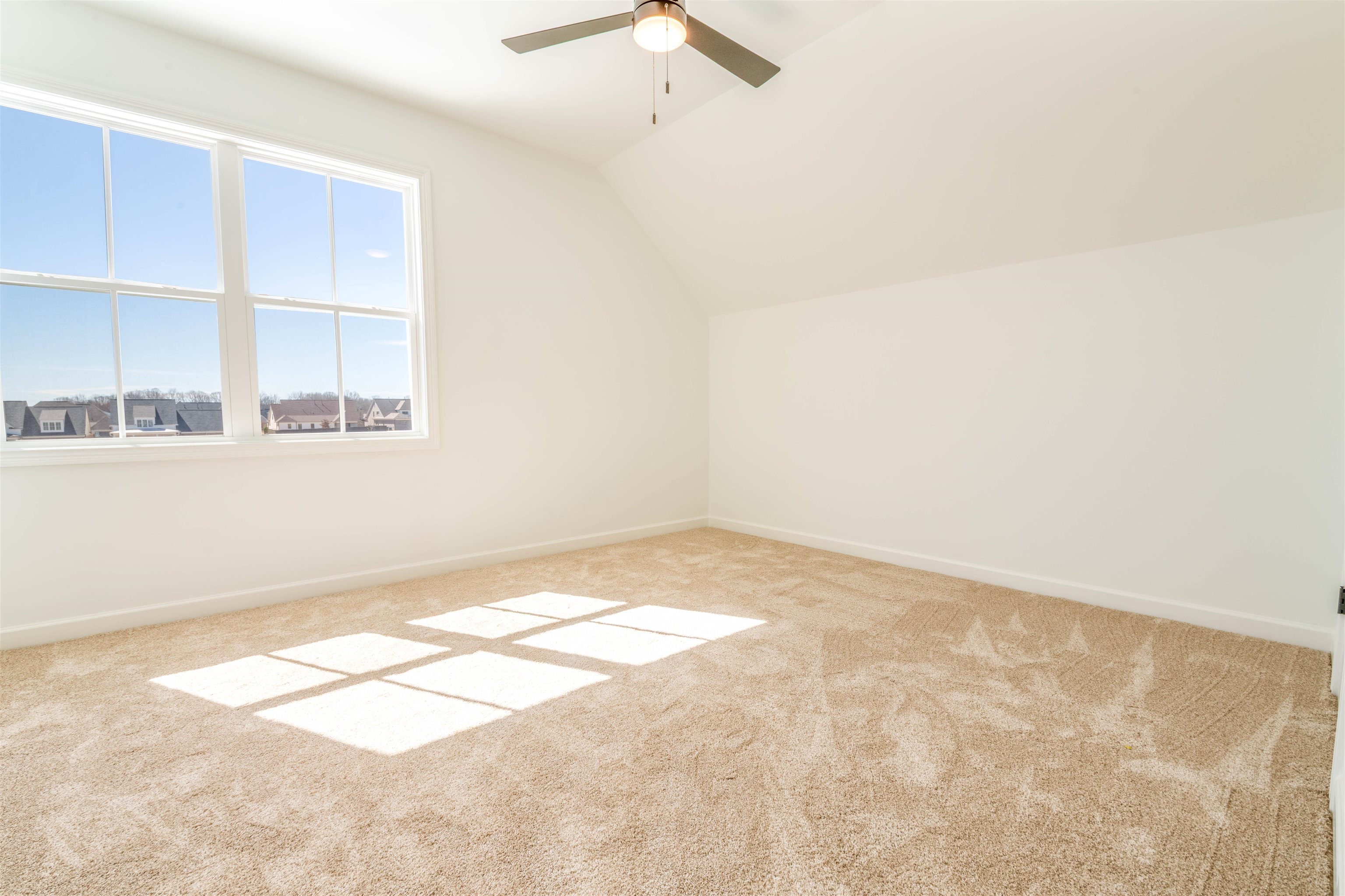 30 Rambling Rex Trail Piperton, TN 38017 - Photo 24 of 27 Additional living space with baseboards, ceiling fan, carpet flooring, and vaulted ceiling