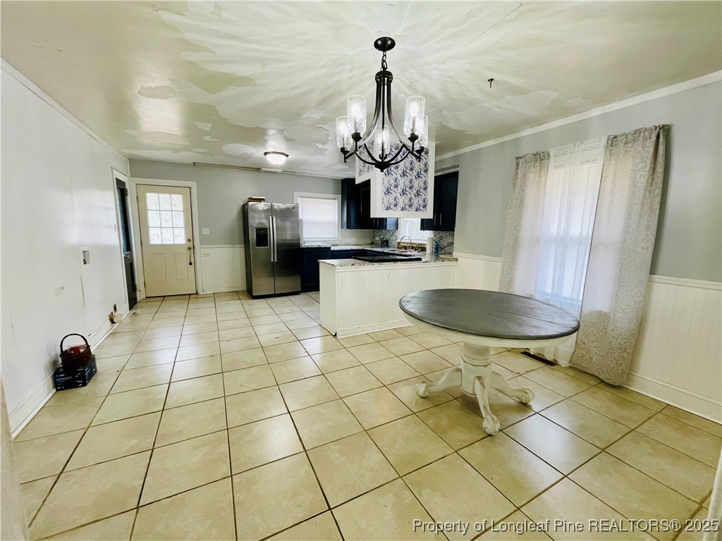 405 South Austin Street Maxton, NC 28364 - Photo 21 of 41 a kitchen with stainless steel appliances a sink cabinets and living room view