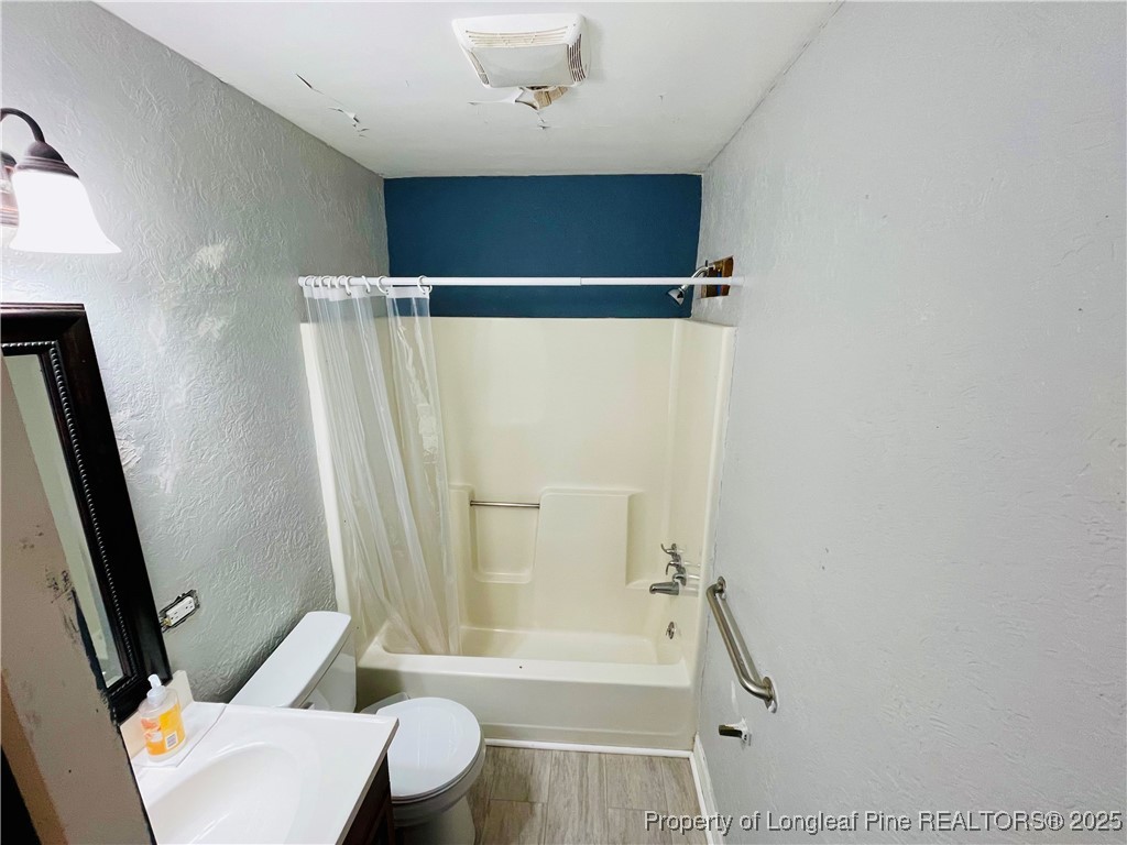 405 South Austin Street Maxton, NC 28364 - Photo 33 of 41 a bathroom with a shower and a toilet
