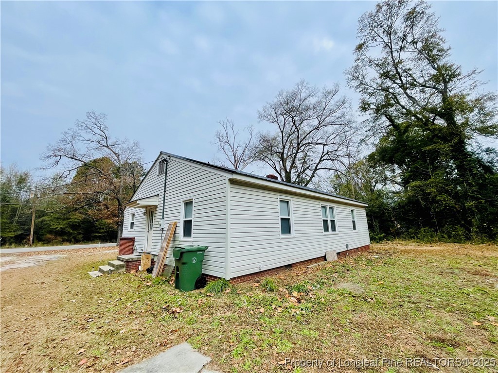 405 South Austin Street Maxton, NC 28364 - Photo 6 of 41 a view of a backyard with large trees and a small yard