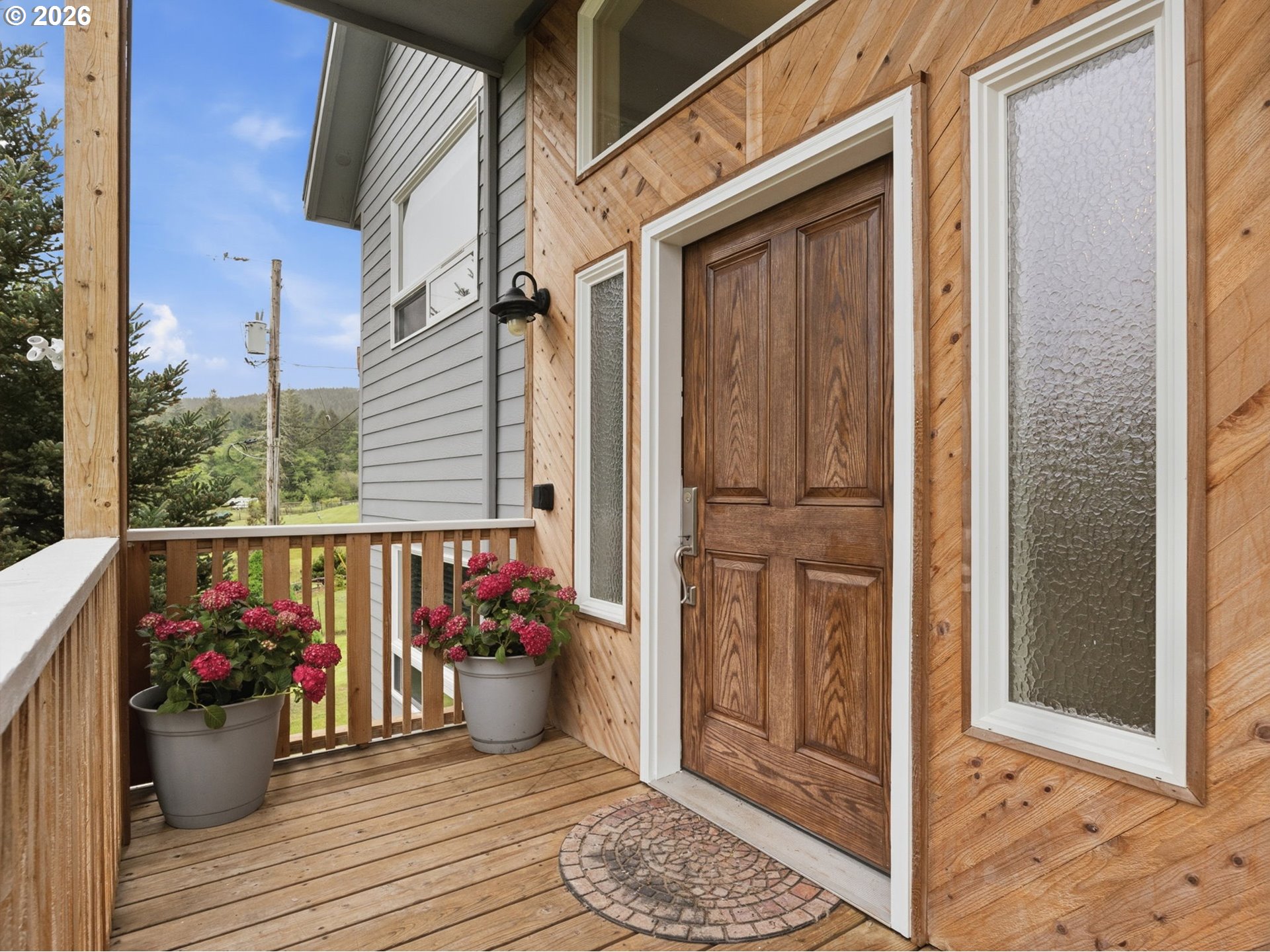 92085 Akerstedt Road Astoria, OR 97103 - Photo 4 of 48 a view of a balcony with furniture and wooden floor