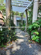 3940 Main, Unit COTTAGE Miami, FL 33133 - Photo 2 of 13 walkway to Cottage
