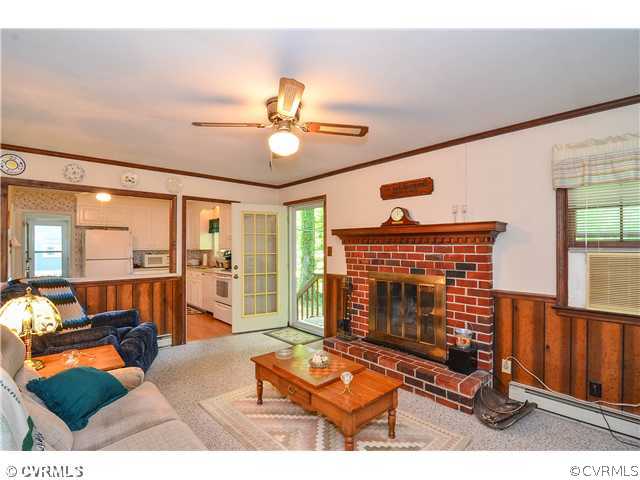 3920 Huntwood Road Richmond, VA 23235 - Photo 12 of 20 a living room with furniture a fireplace and wooden floor