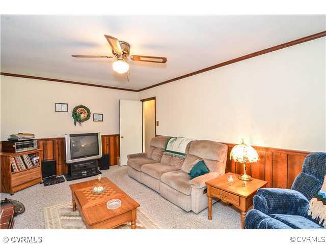 3920 Huntwood Road Richmond, VA 23235 - Photo 13 of 20 a living room with furniture and a flat screen tv