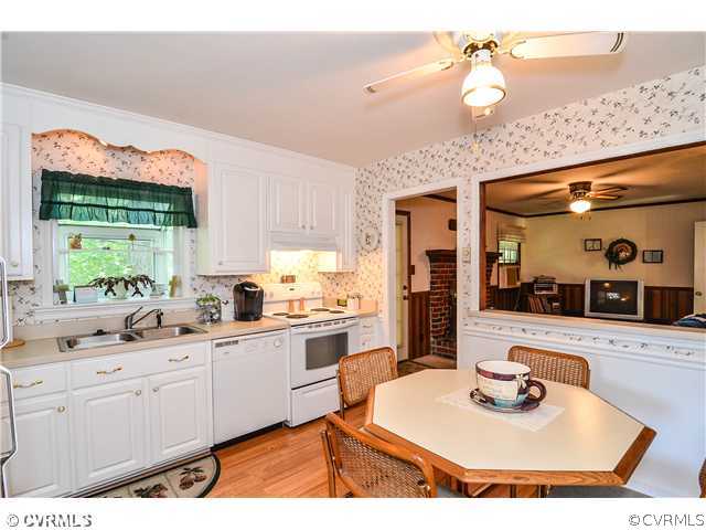 3920 Huntwood Road Richmond, VA 23235 - Photo 14 of 20 a kitchen with a sink stove and cabinets