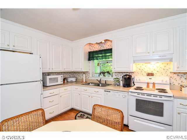 3920 Huntwood Road Richmond, VA 23235 - Photo 15 of 20 a kitchen with a sink stove and cabinets