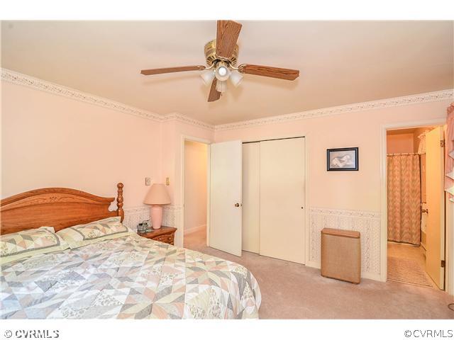 3920 Huntwood Road Richmond, VA 23235 - Photo 9 of 20 a bedroom with a bed and cabinets