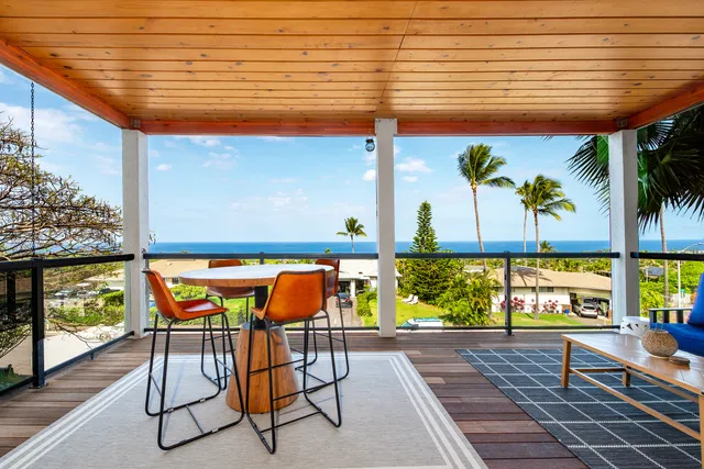 a view of a hallway with furniture and a window