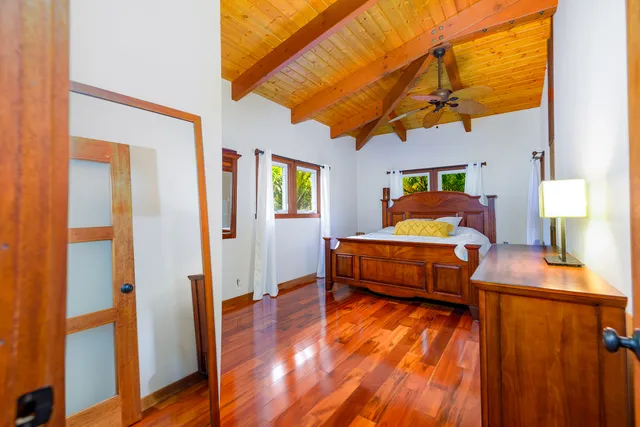 a bedroom with furniture and wooden floor