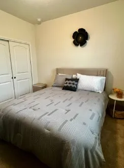 a bedroom with furniture and a flat screen tv