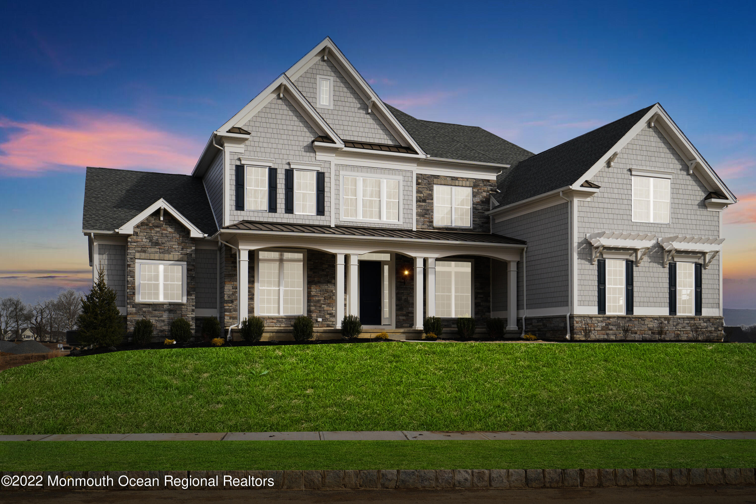 a front view of a house with a garden and plants