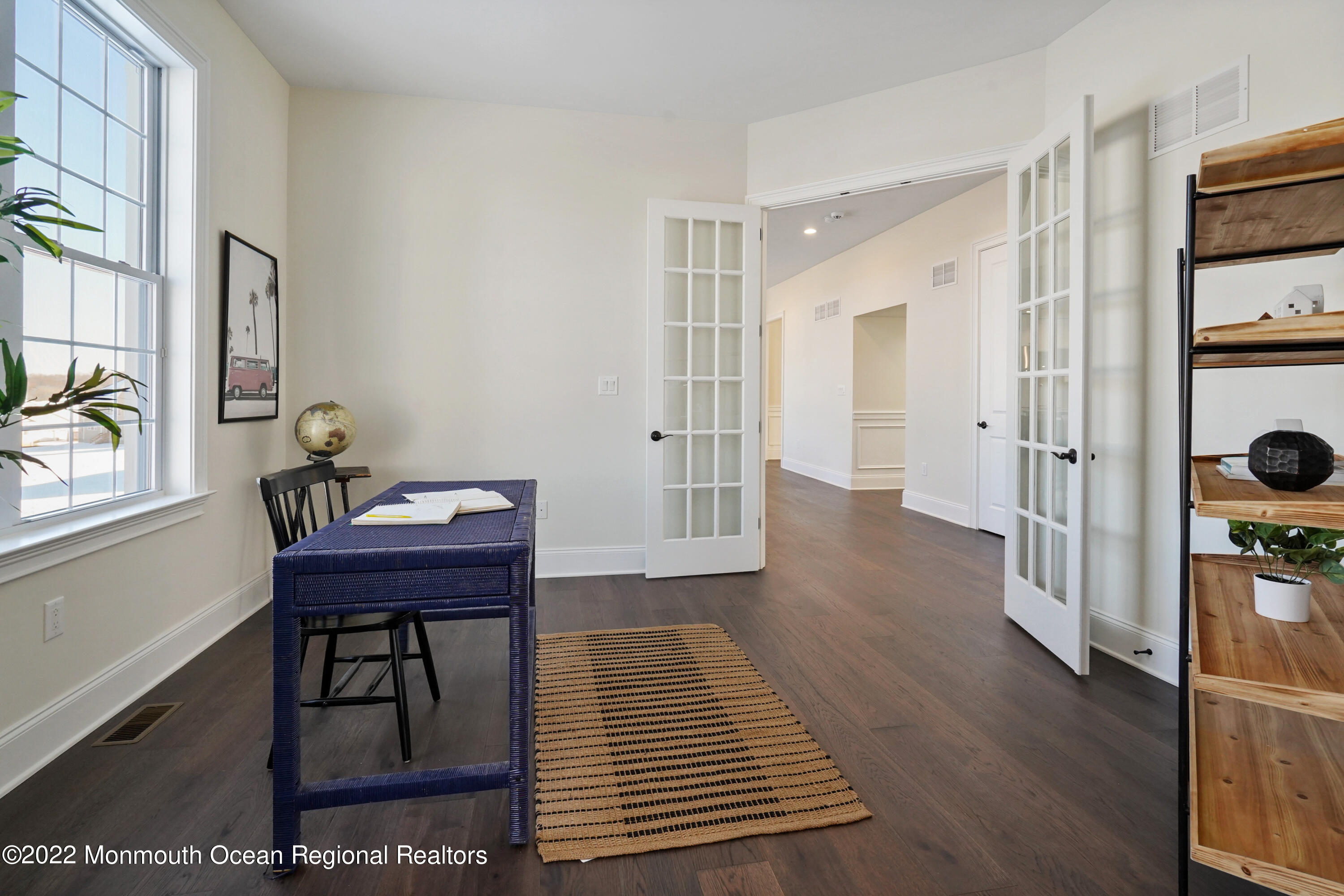 66 Windermere Road Lincroft, NJ 07738 - Photo 22 of 61 a view of a hallway to a livingroom with furniture wooden floor and windows