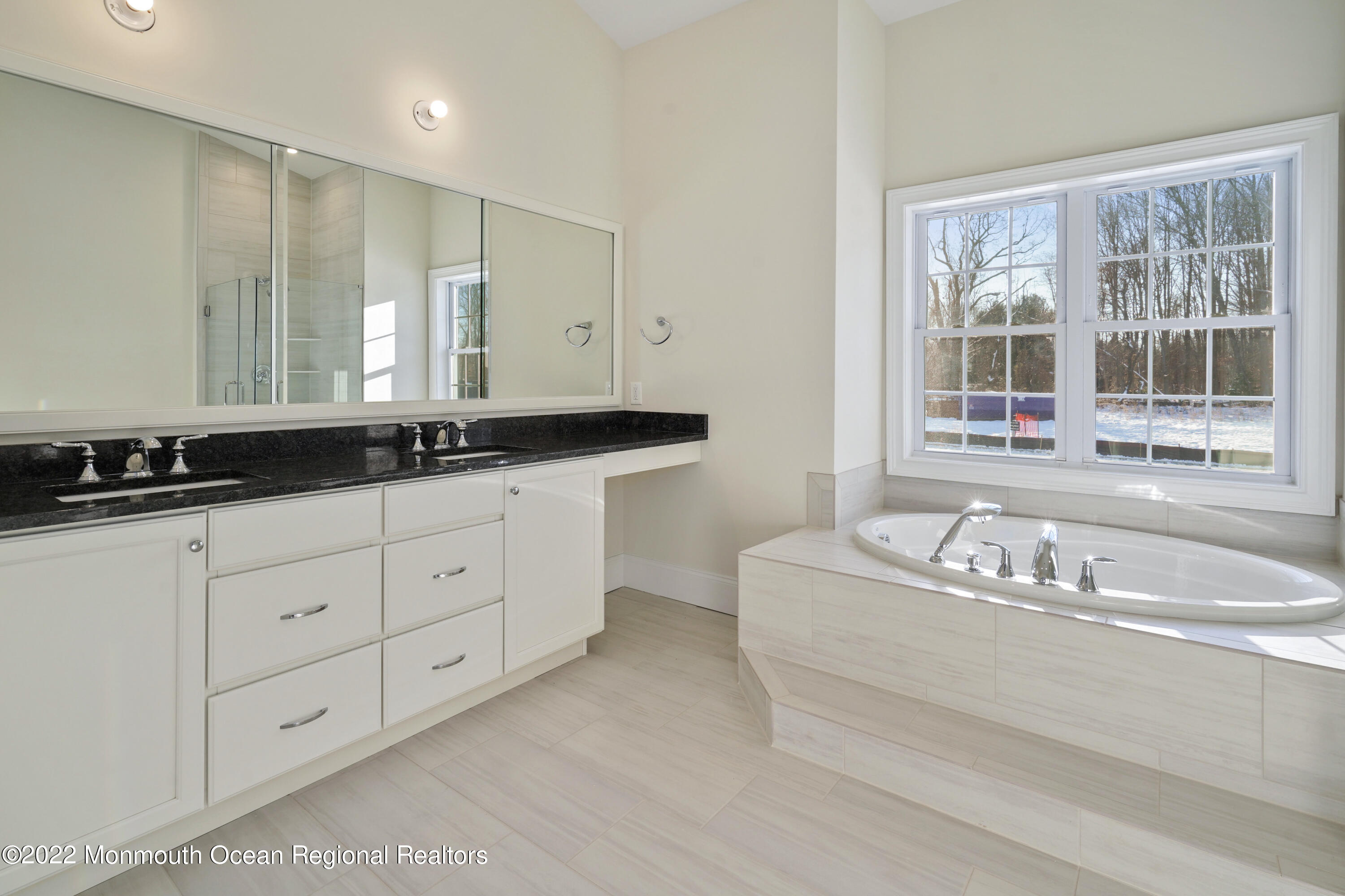 66 Windermere Road Lincroft, NJ 07738 - Photo 25 of 61 a bathroom with a bathtub a double vanity sink and mirror