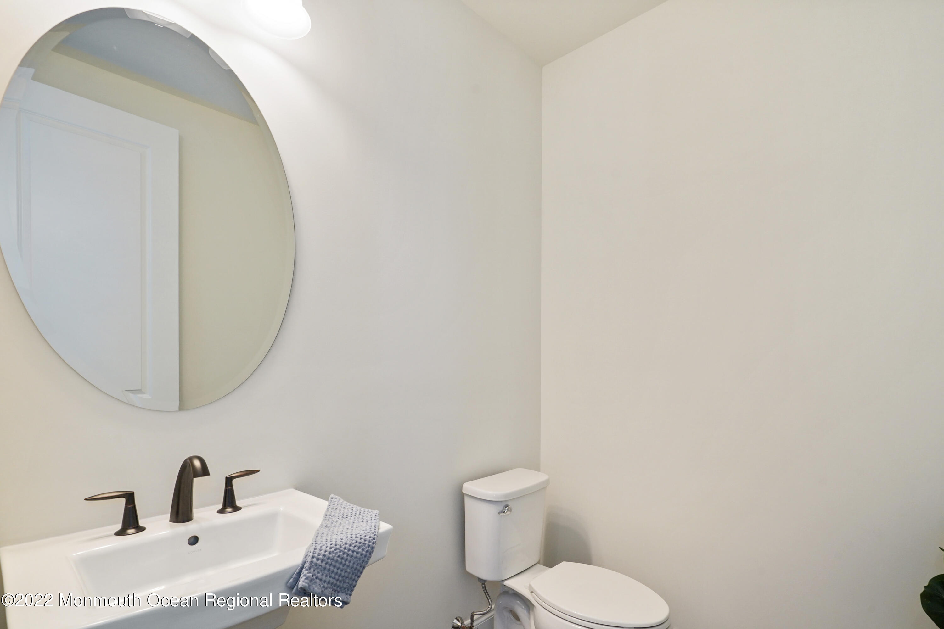 66 Windermere Road Lincroft, NJ 07738 - Photo 27 of 61 a bathroom with a toilet sink and mirror