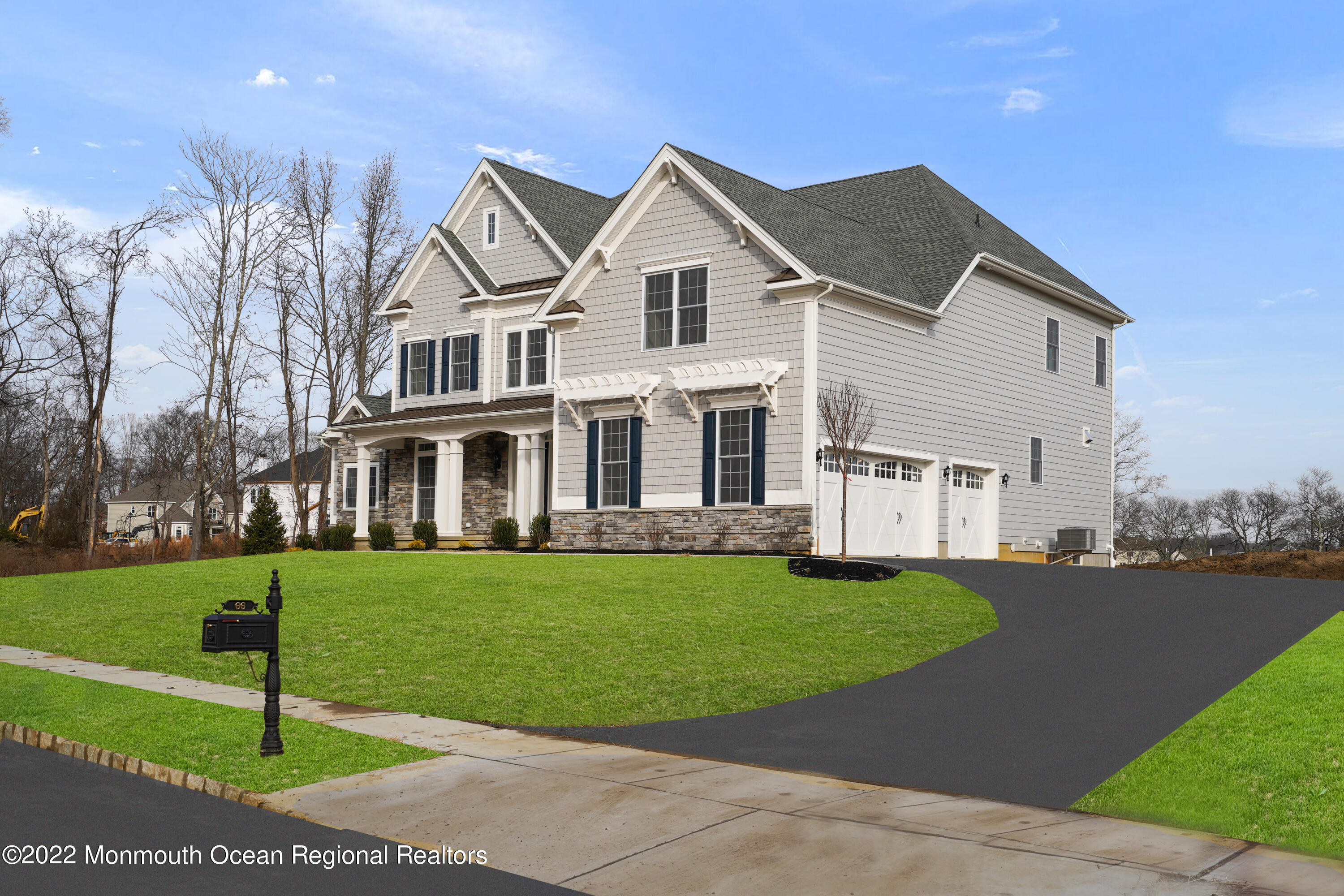 66 Windermere Road Lincroft, NJ 07738 - Photo 5 of 61 a front view of a house with a garden and yard