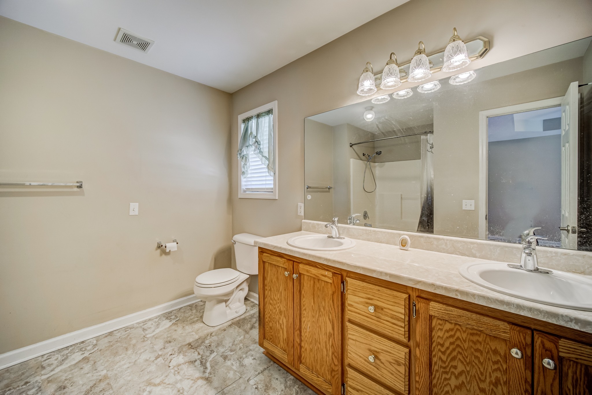 5160 Minnis Road Springfield, TN 37172 - Photo 22 of 31 a bathroom with a sink a toilet a large mirror and vanity