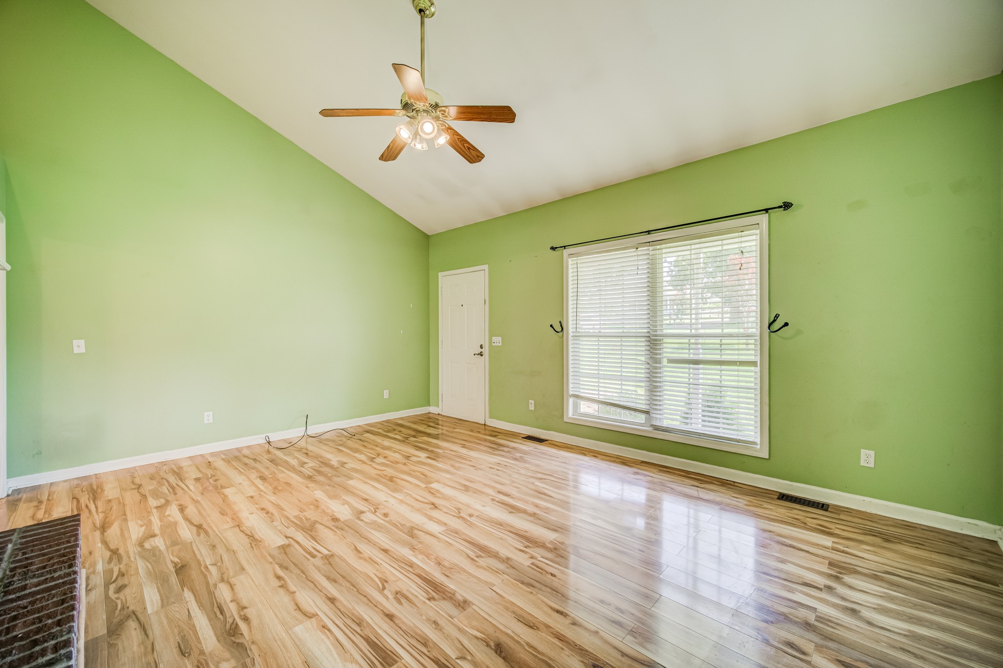 5160 Minnis Road Springfield, TN 37172 - Photo 7 of 31 a view of an empty room with wooden floor and a window