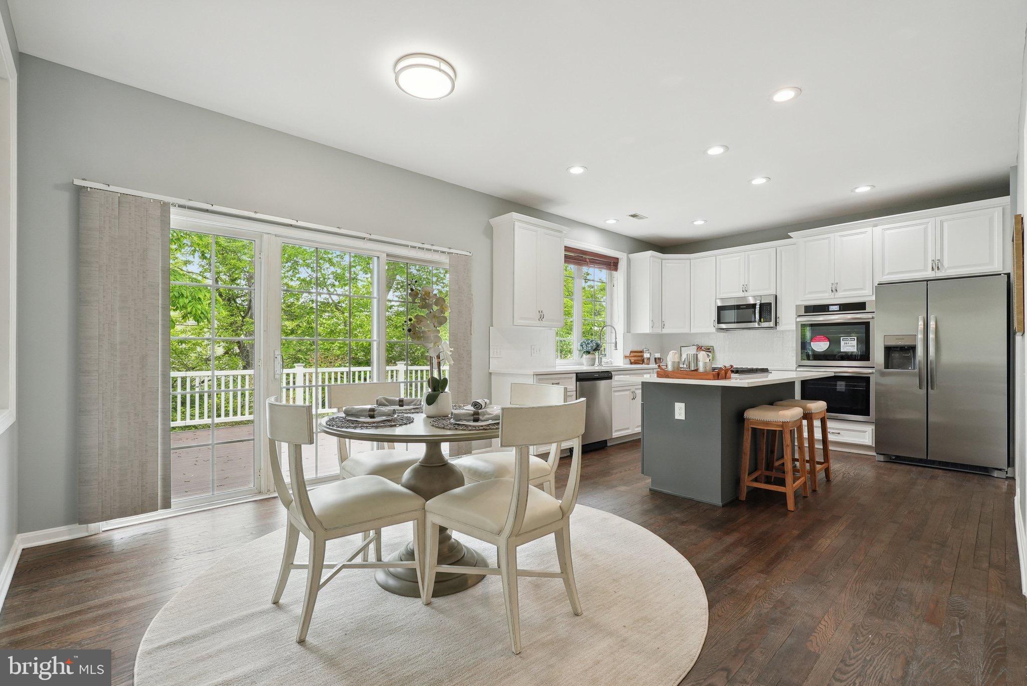 51 Knickerbocker Lane Malvern, PA 19355 - Photo 23 of 57 a open dining room with stainless steel appliances a dining table wooden floor and a large window