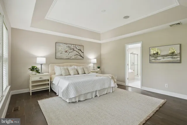 a bedroom with a bed and a potted plant