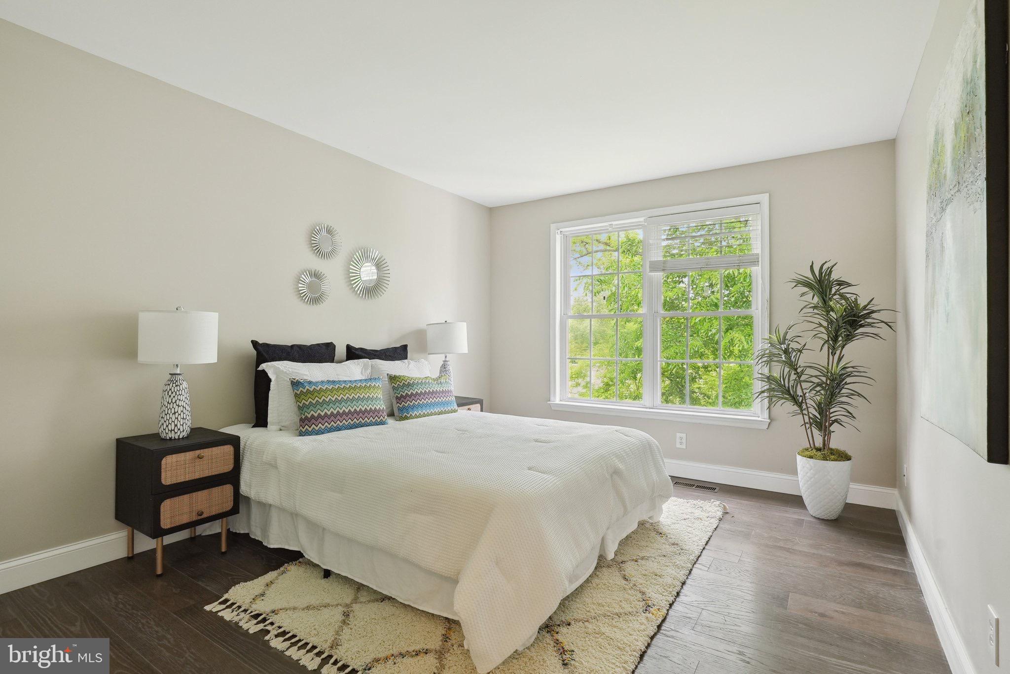 51 Knickerbocker Lane Malvern, PA 19355 - Photo 40 of 57 a bedroom with a bed and a potted plant