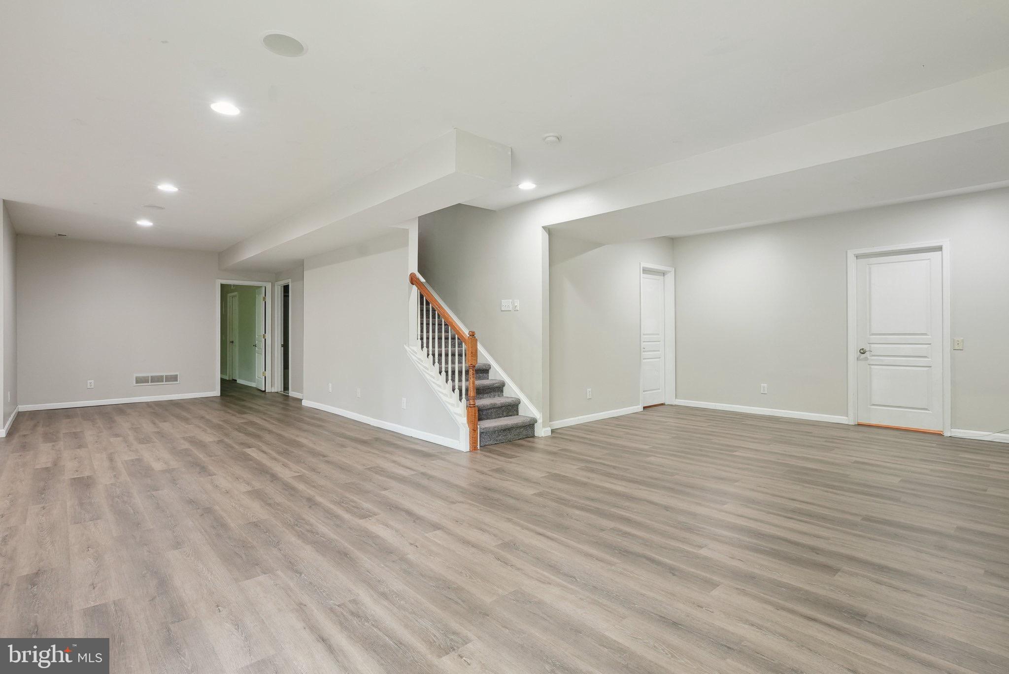 51 Knickerbocker Lane Malvern, PA 19355 - Photo 48 of 57 a view of an empty room with wooden floor and stairs