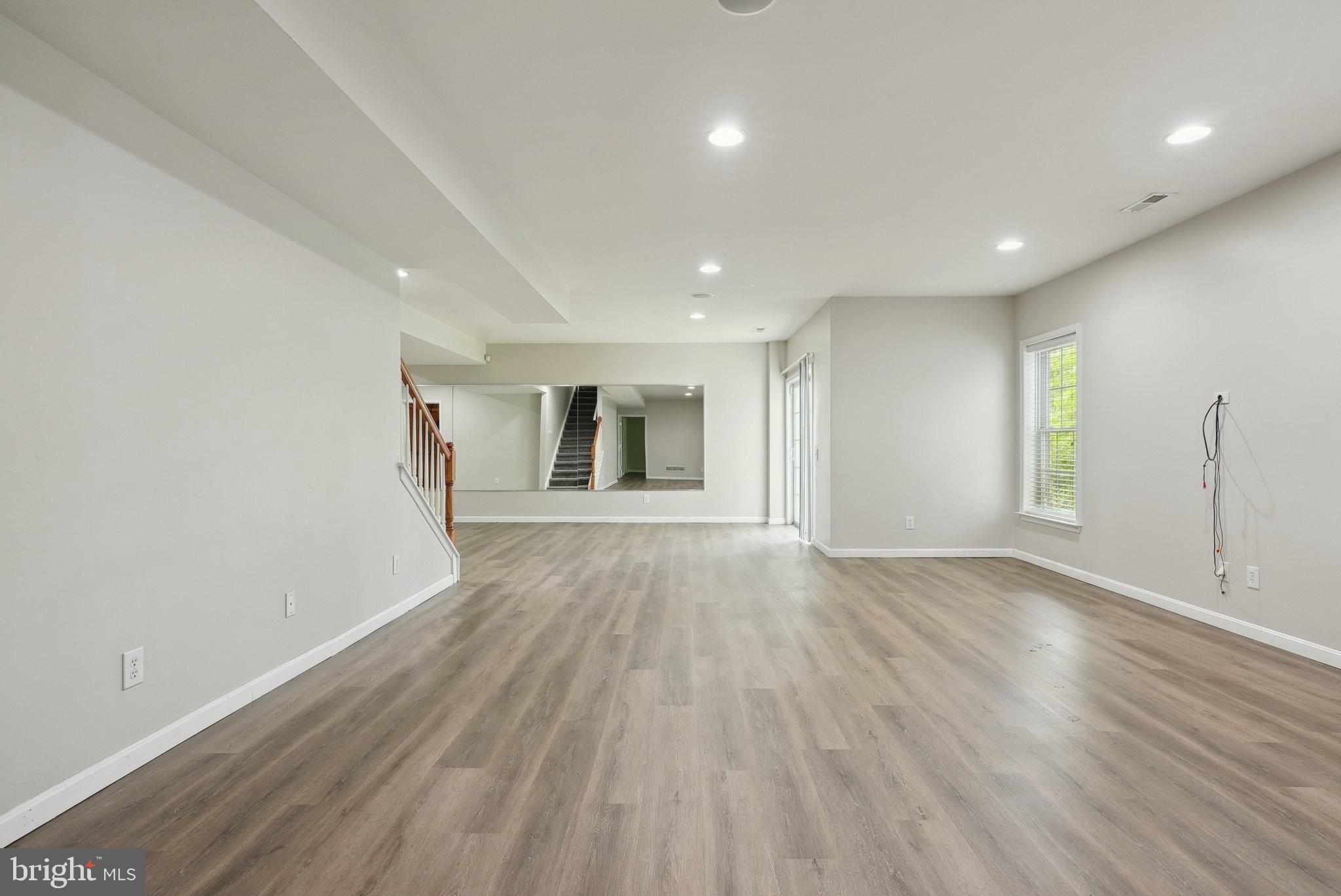 51 Knickerbocker Lane Malvern, PA 19355 - Photo 50 of 57 an empty room with wooden floor and windows