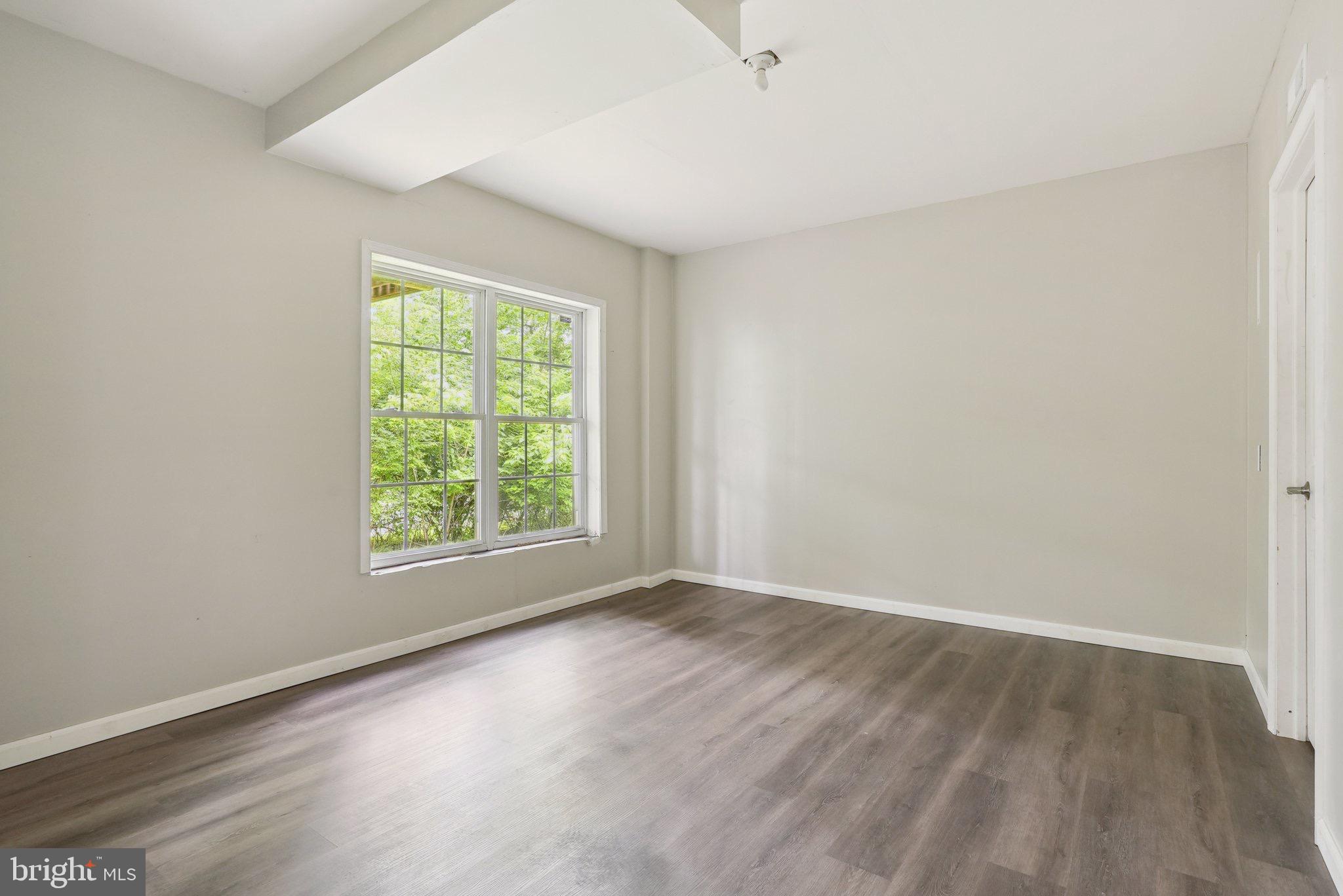 51 Knickerbocker Lane Malvern, PA 19355 - Photo 54 of 57 an empty room with wooden floor and windows