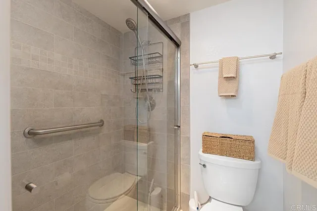 a bathroom with a sink double vanity granite tub shower and a mirror