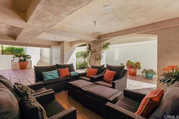 a view of balcony with two chairs and a potted plant