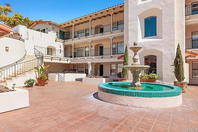 a front view of a building with outdoor seating