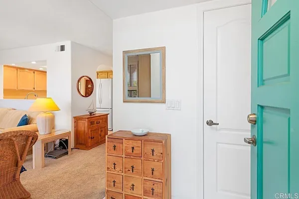 a living room with furniture a flat screen tv and a window