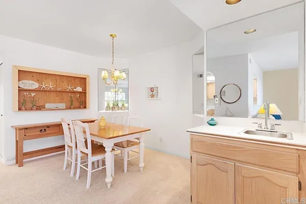 a dining room with furniture a window and a chandelier