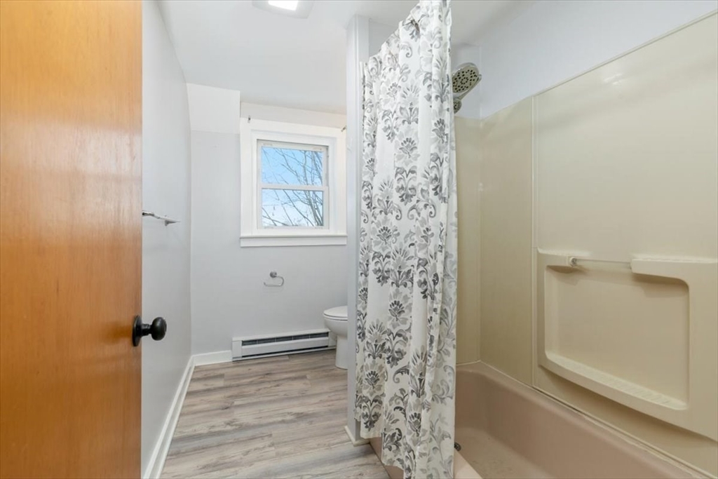 129 Friend Street, Unit 3 Amesbury, MA 01913 - Photo 15 of 30 a bathroom with a shower curtain and a window