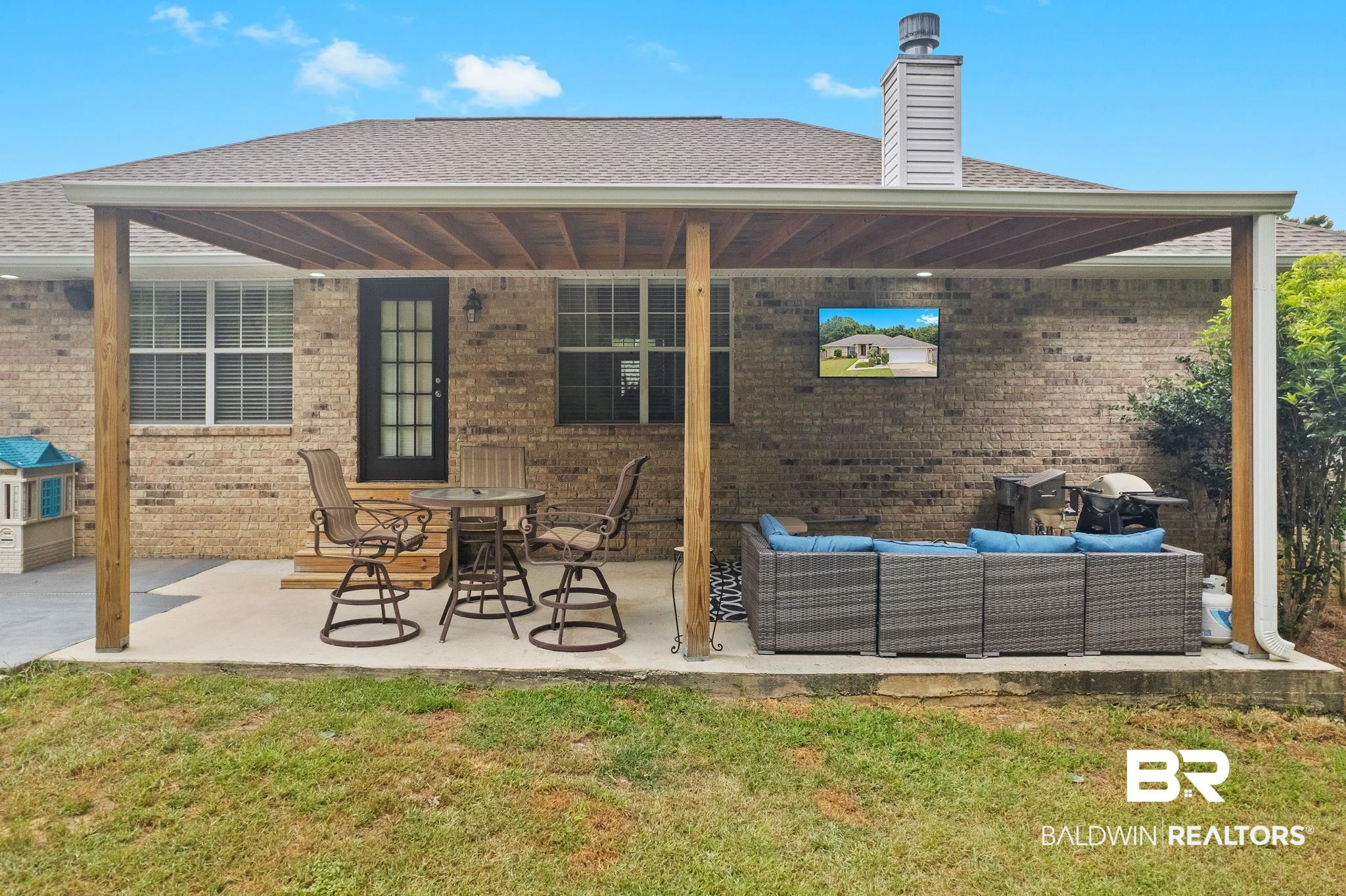 28246 Turkey Branch Drive Daphne, AL 36526 - Photo 26 of 41 Back of property featuring an outdoor hangout area, a yard, and a patio area