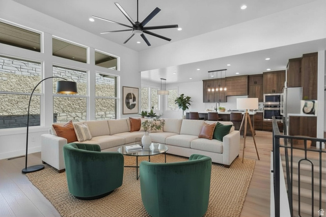 710 East Mountain Road North Ogden, UT 84414 - Photo 5 of 36 Enhanced staged photo Living area featuring a ceiling fan, light wood-style flooring, a high ceiling, and recessed lighting
