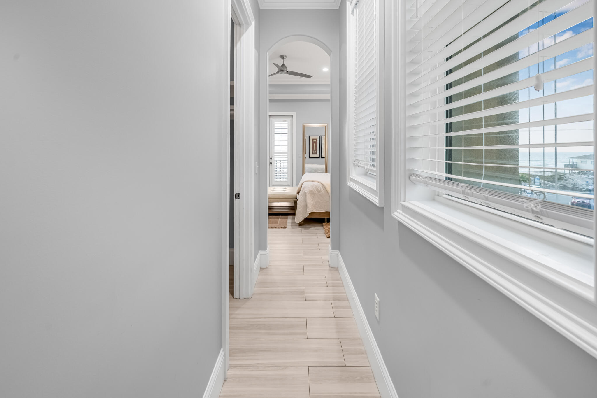 5732 West County Highway 30A Santa Rosa Beach, FL 32459 - Photo 11 of 43 a view of a hallway with wooden floor and windows