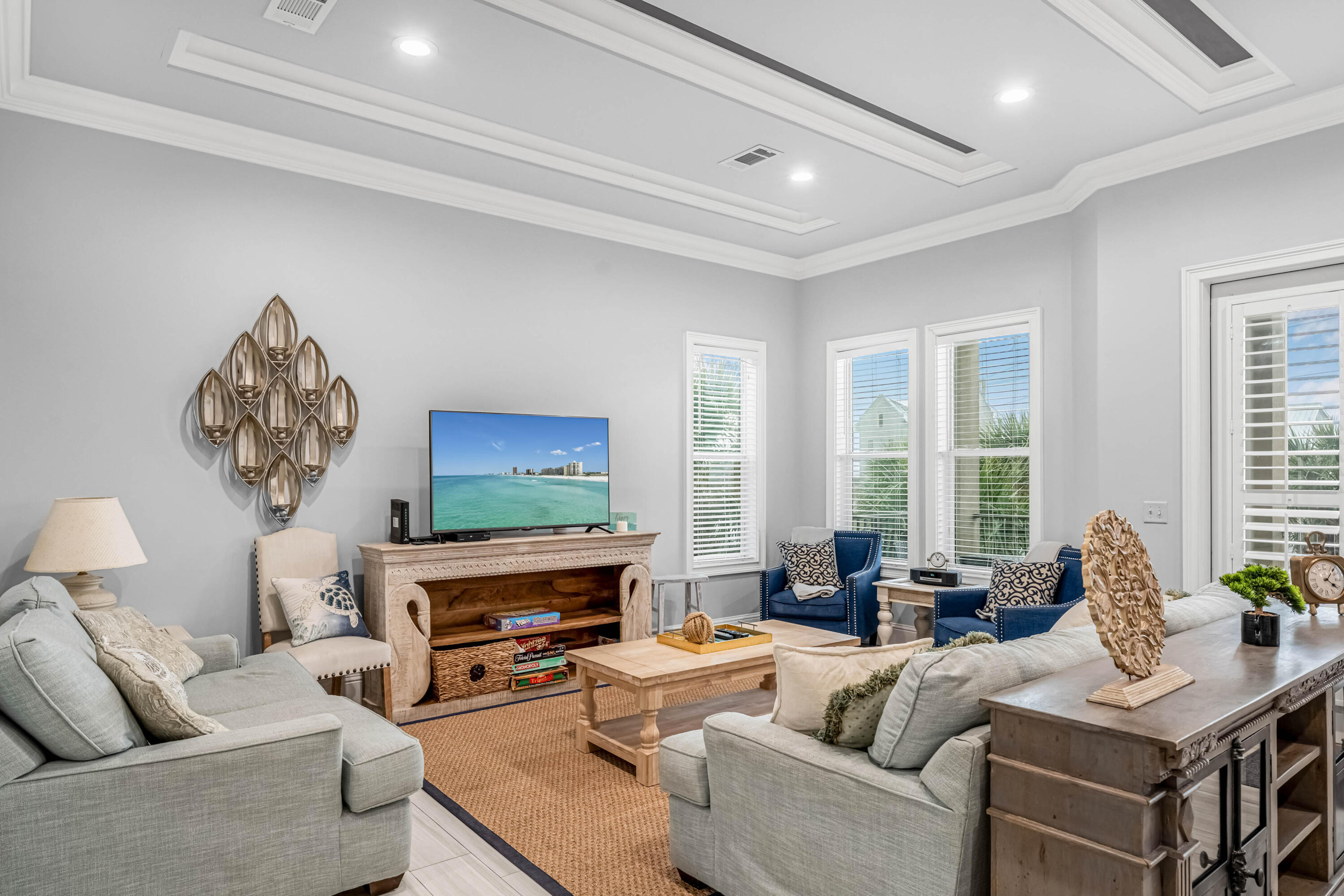 5732 West County Highway 30A Santa Rosa Beach, FL 32459 - Photo 23 of 43 a living room with furniture a fireplace and a flat screen tv