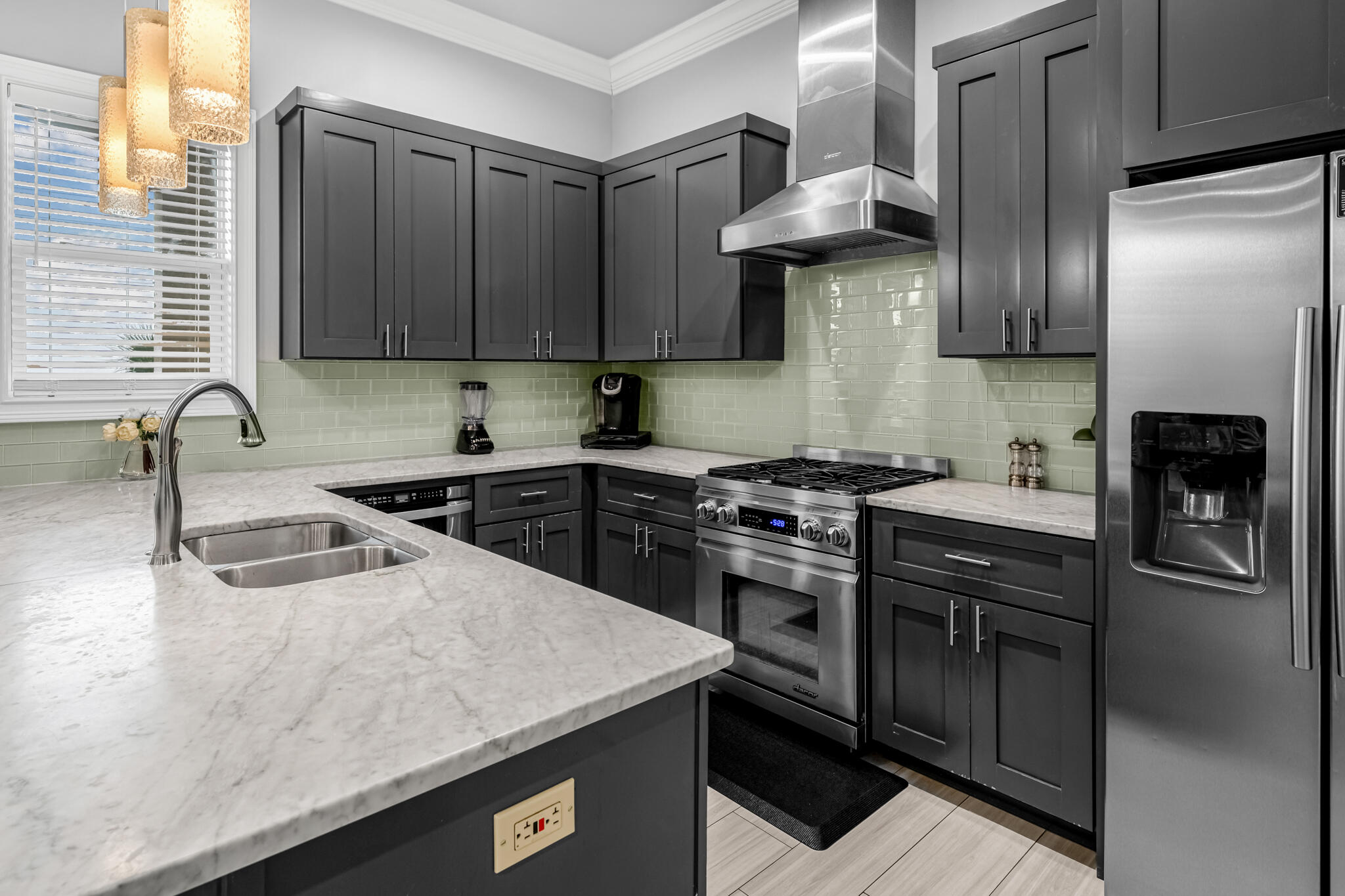 5732 West County Highway 30A Santa Rosa Beach, FL 32459 - Photo 25 of 43 a kitchen with stainless steel appliances granite countertop a sink stove and refrigerator